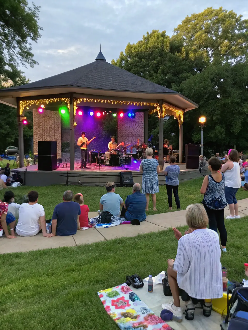 A community outreach program in action, showing musicians performing for and engaging with diverse audiences in a public space, supported by the Canberra International Music Festival.
